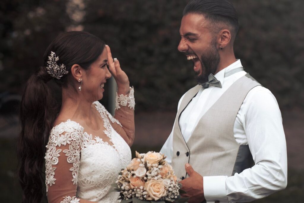 Bride and groom laughing.